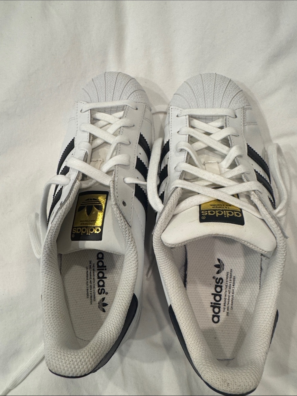 adidas women’s black and white Superstar Sneakers